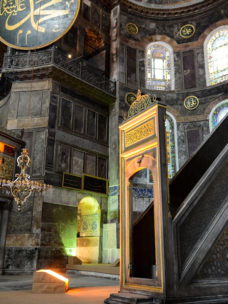 Hagia Sophia minbar with intricate carvings and stained glass windows in Istanbul, Turkey.