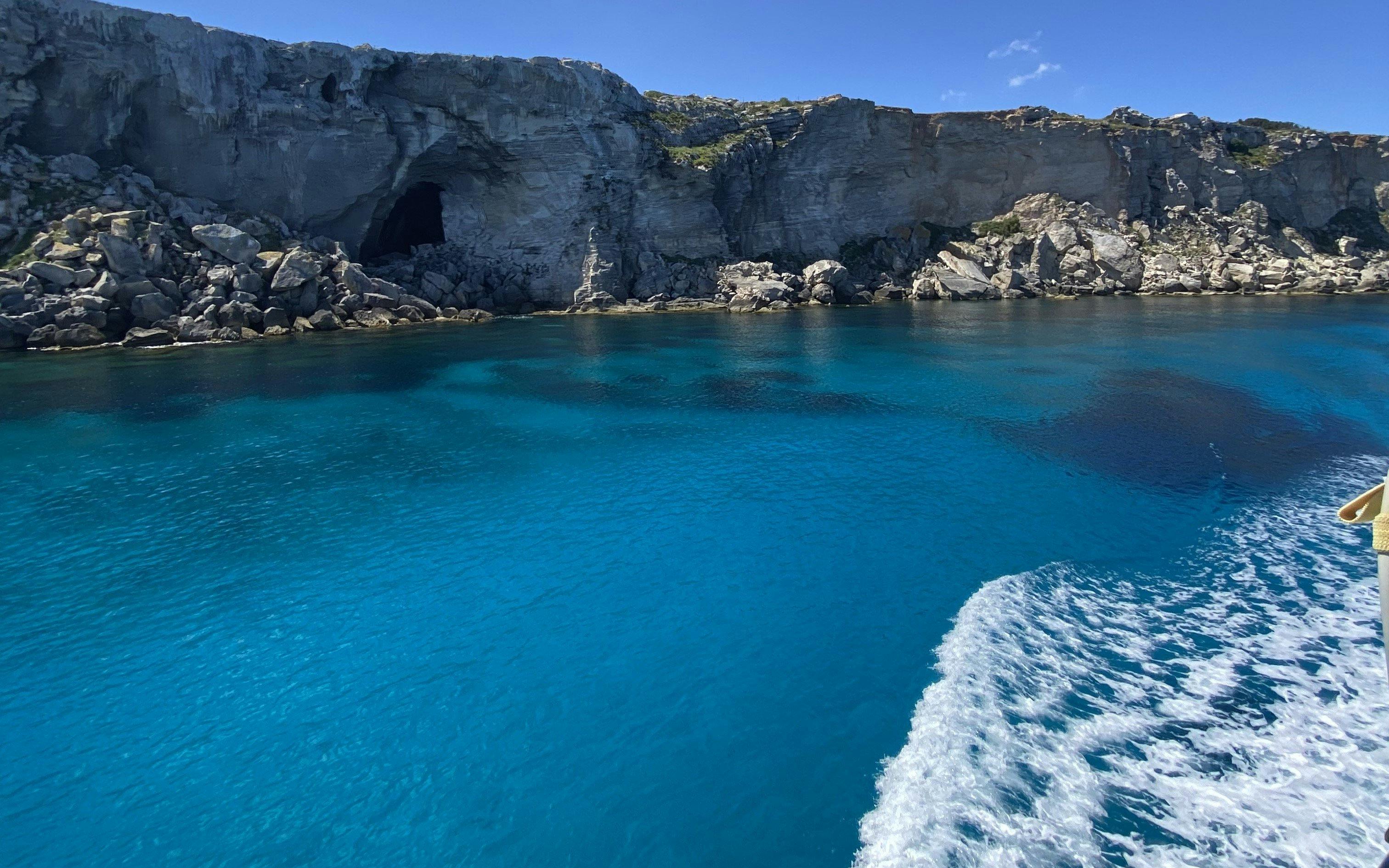 Cruise view of rocky coastline and clear blue waters near Favignana, Sicily.