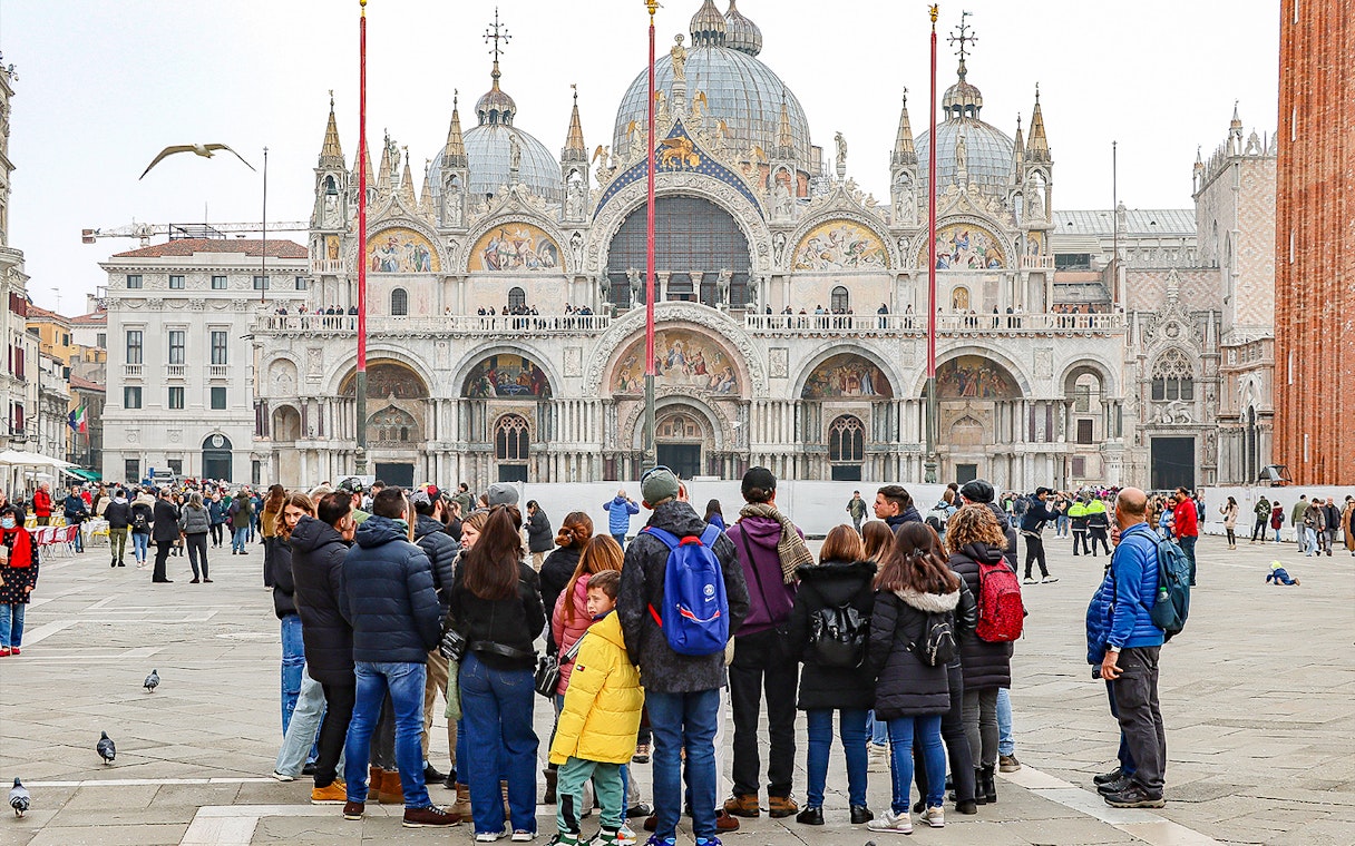 Tour group in front of St. Mark's Basilica, Venice, during a guided walking tour.