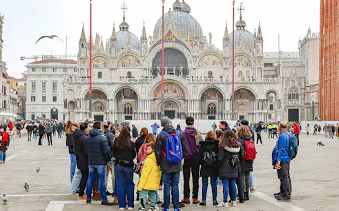 Tour group in front of St. Mark's Basilica, Venice, during a guided walking tour.