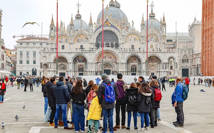 Tour group in front of St. Mark's Basilica, Venice, during a guided walking tour.