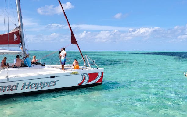 Catamaran sailing to Ile aux Cerfs from Pointe Jerome with passengers enjoying the ocean view.