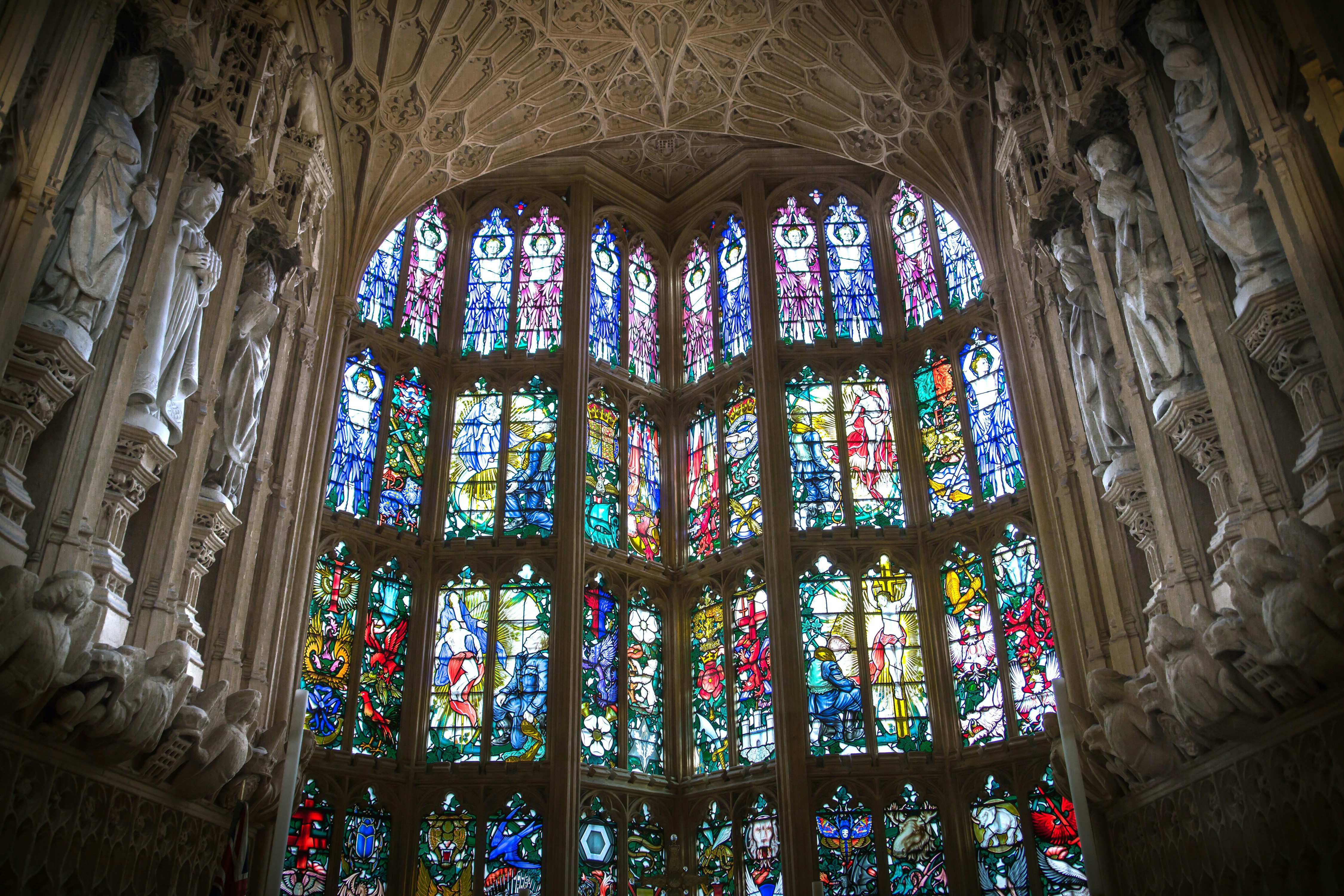 Stained glass windows in a cathedral with intricate stone carvings.