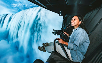 Visitors enjoying a simulated flight over Niagara Falls, Canada.