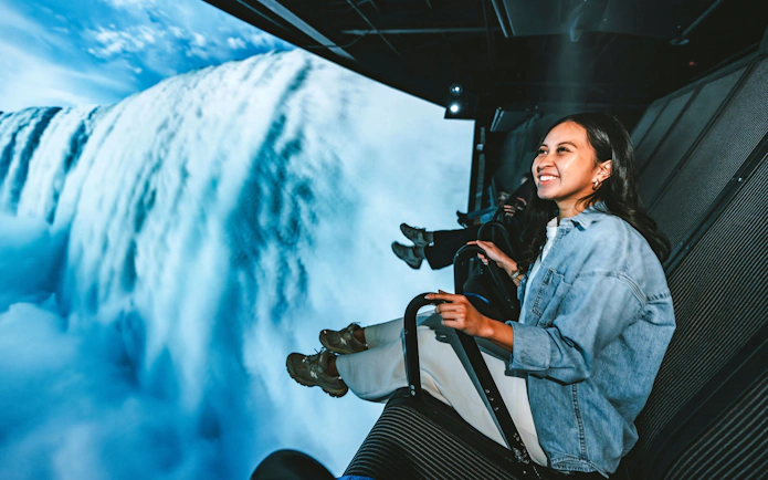 Visitors enjoying a simulated flight over Niagara Falls, Canada.
