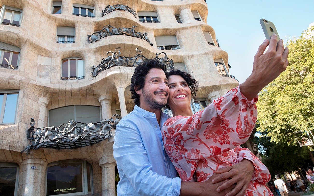 Couple taking a selfie in front of La Pedrera, Barcelona.