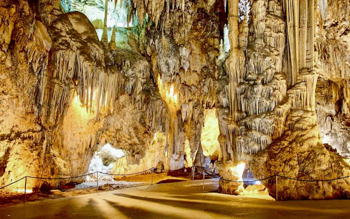 Stalactites and stalagmites in the illuminated Caves of Nerja, Spain.