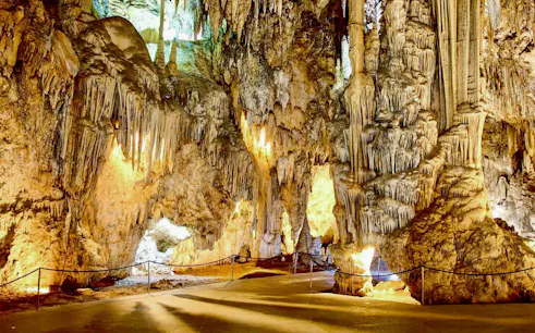 Stalactites and stalagmites in the illuminated Caves of Nerja, Spain.