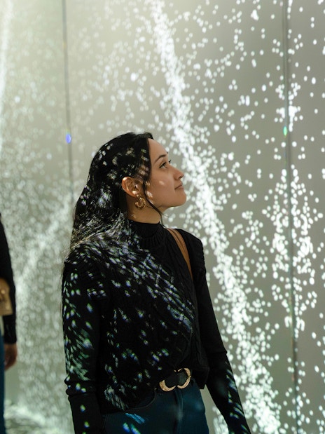 Guest exploring mirrored light display at World of Illusion, Dublin.