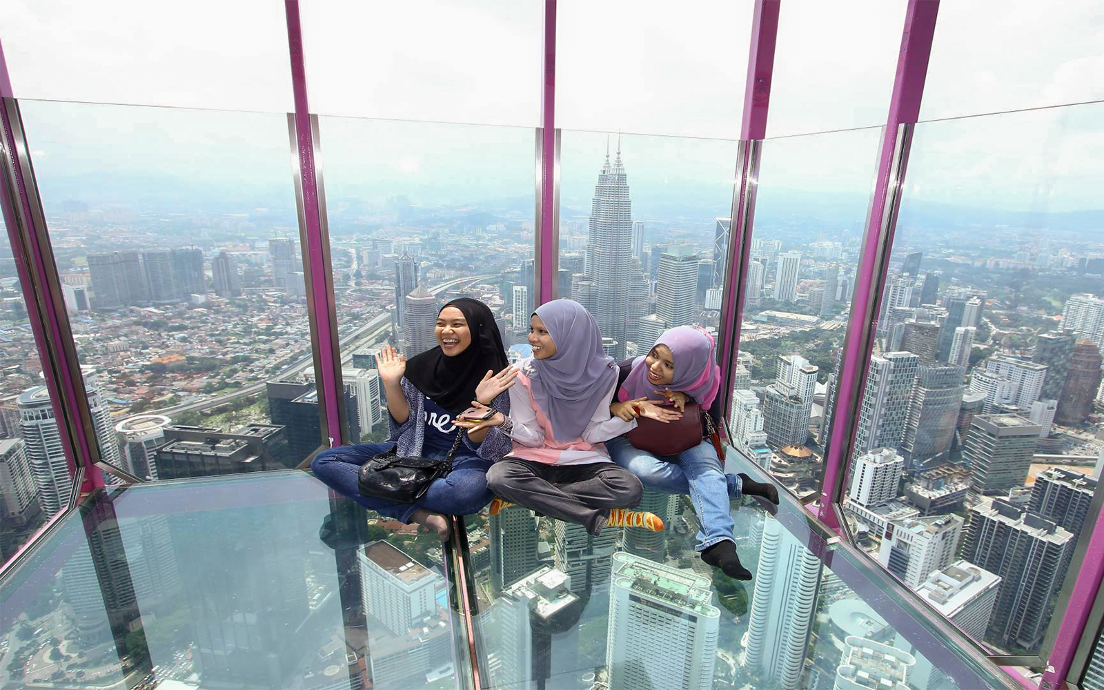 Visitors enjoying the view from KL Tower SkyBox, Kuala Lumpur, Malaysia.
