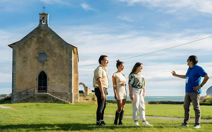 Tourist group with guide at Santa Catalina Hermitage in Mundaka.