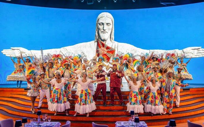 Performers in colorful costumes on stage at Roxy Dinner Show, Rio de Janeiro.