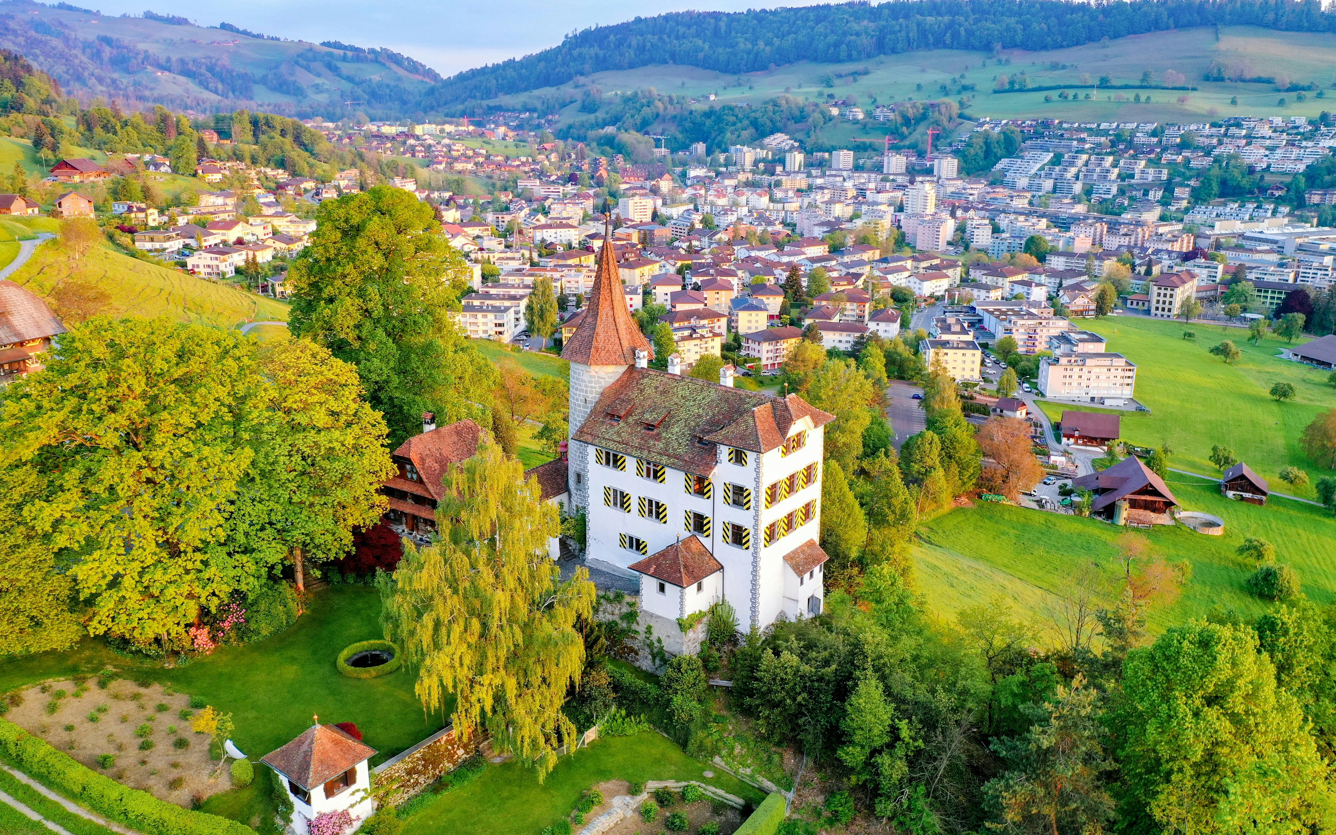 Aerial view of Schloss Schauensee surrounded by greenery in Kriens, Lucerne, Switzerland.