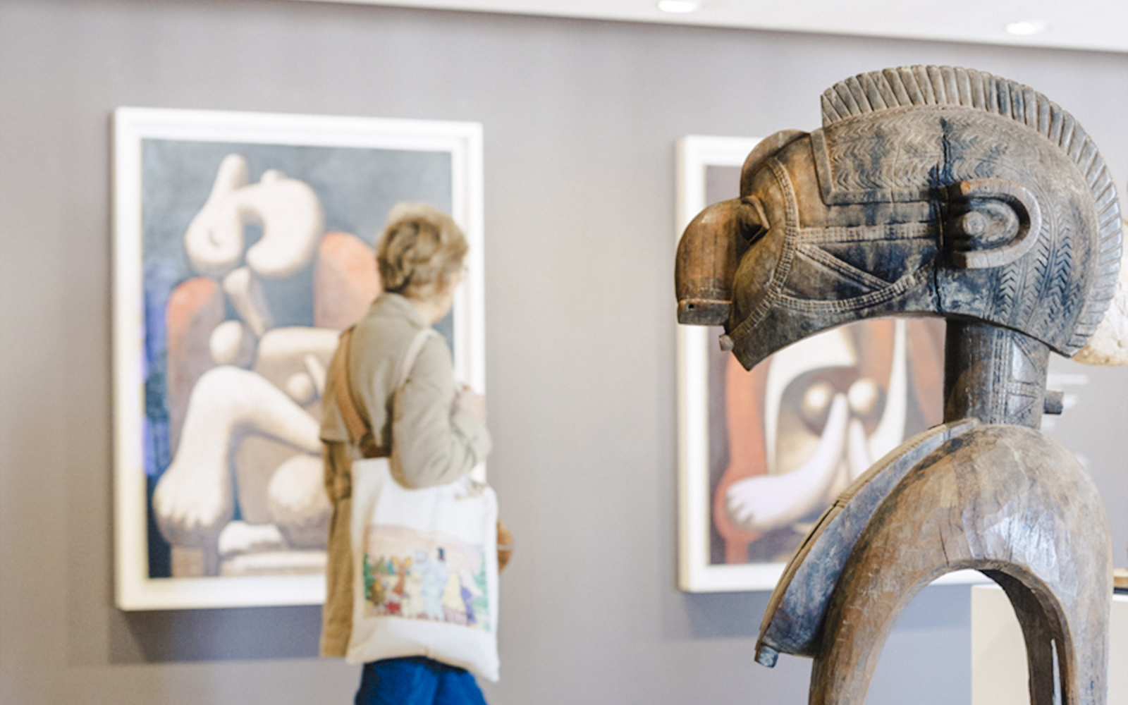 Wooden sculpture and abstract paintings in Picasso Museum, Paris, France.