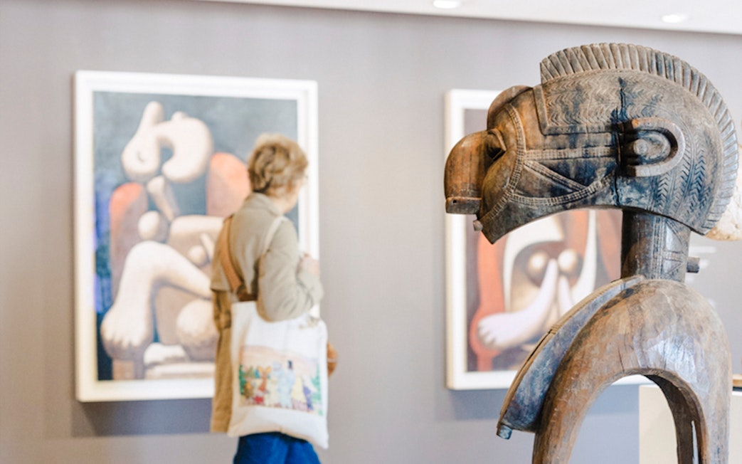 Wooden sculpture and abstract paintings in Picasso Museum, Paris, France.