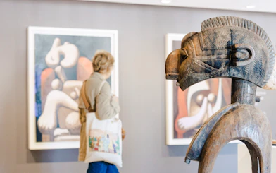 Wooden sculpture and abstract paintings in Picasso Museum, Paris, France.