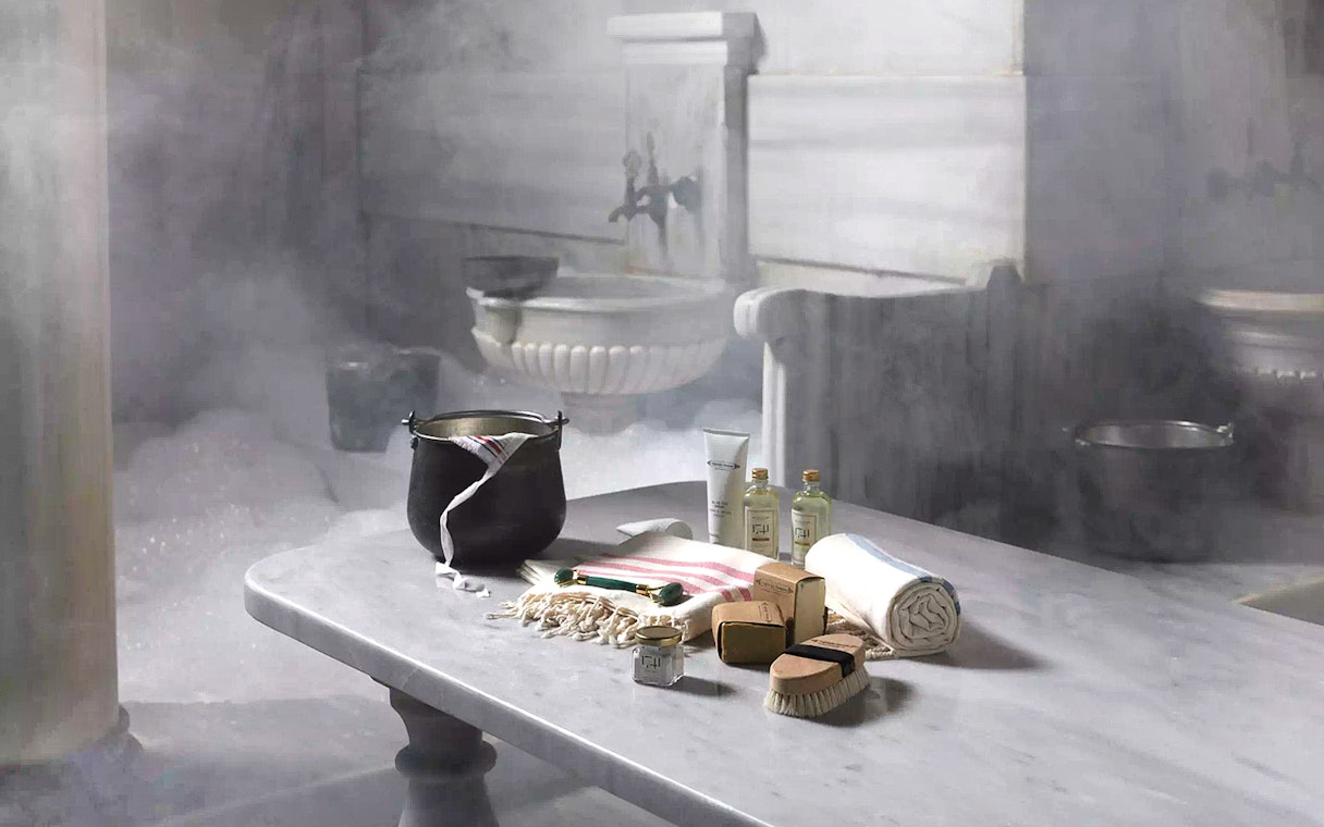 Cagaloglu Hammam interior with traditional bathing items on a marble table, Istanbul.