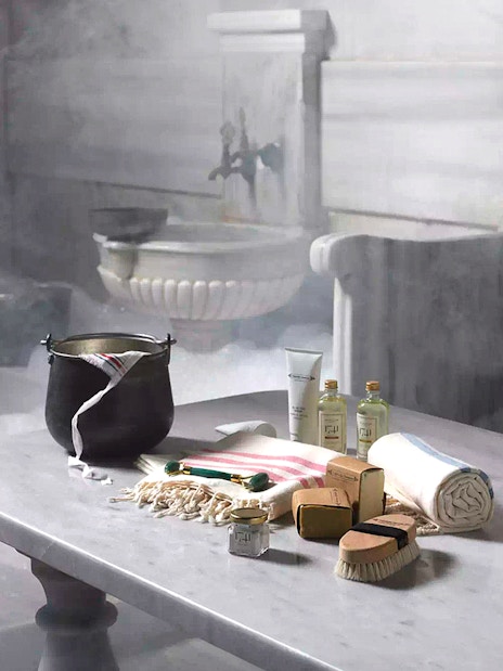 Cagaloglu Hammam interior with traditional bathing items on a marble table, Istanbul.