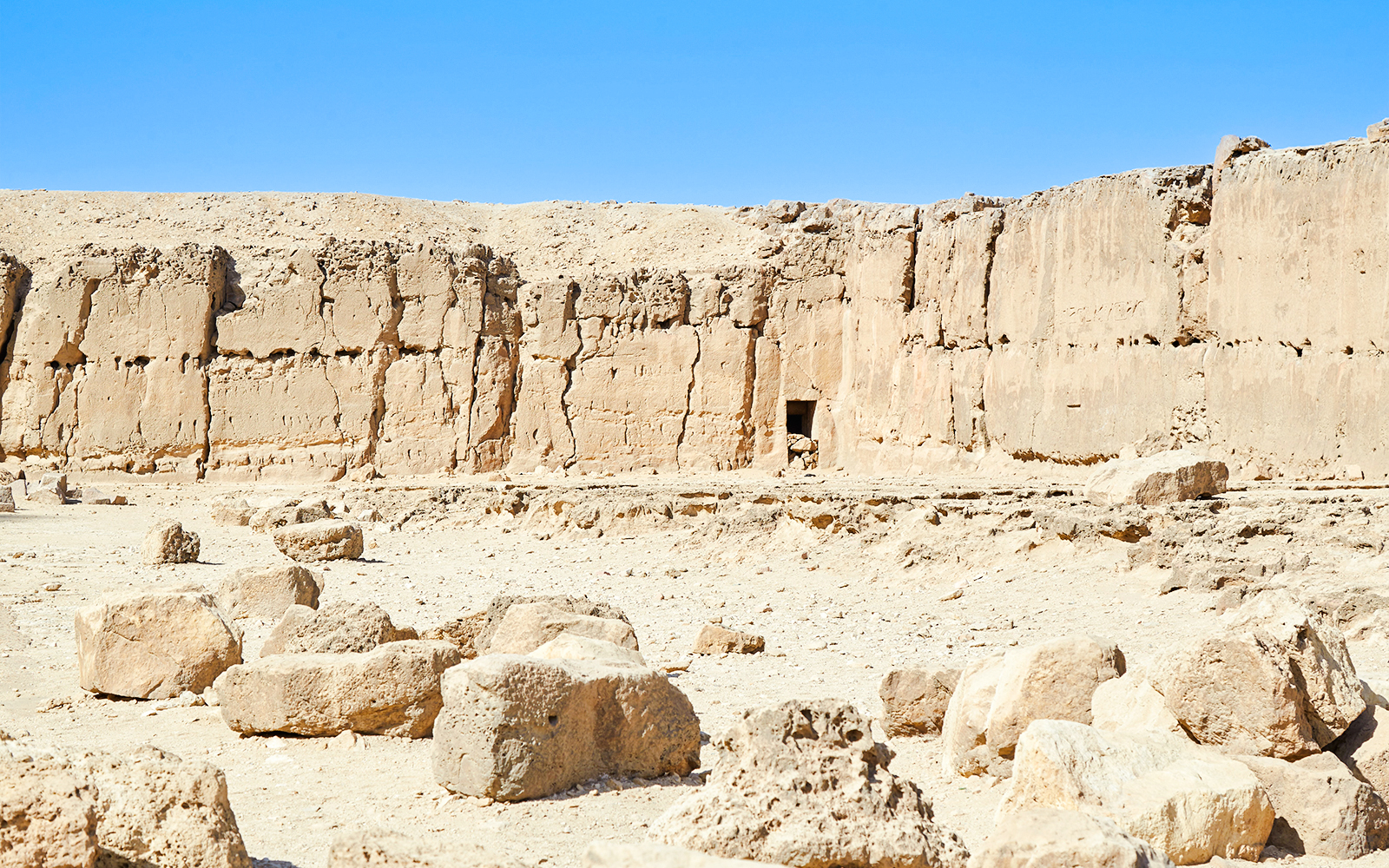 Ancient stone wall and ruins near the Pyramid of Khafre at Giza, Egypt.