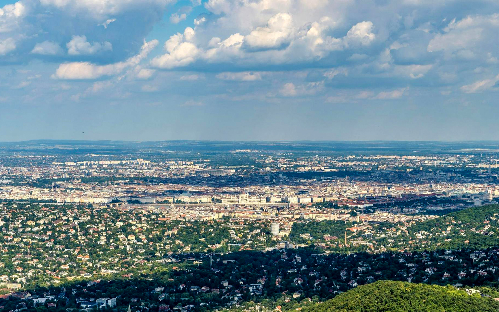 View of Budapest from Janos Hill Lookout Tower, showcasing cityscape and surrounding greenery.