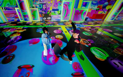 Visitors enjoying vibrant digital art projections at House Of Hype.