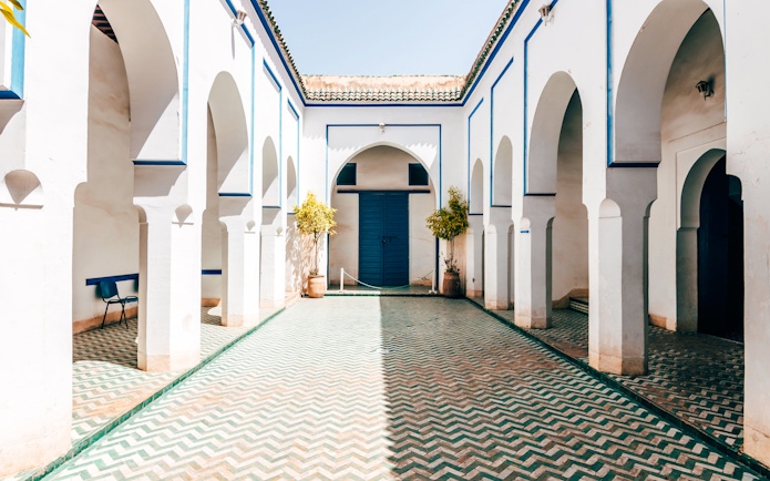 Bahia Palace courtyard with arches and patterned tiles, Marrakech.
