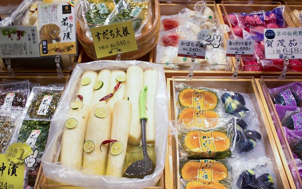 Assorted pickled vegetables at Nishiki Market, Kyoto, featuring daikon and squash.