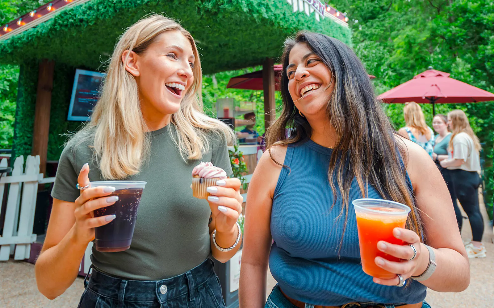 Visitors enjoying drinks and a cupcake at Busch Gardens Williamsburg.