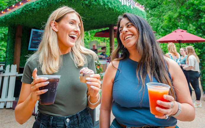 Visitors enjoying drinks and a cupcake at Busch Gardens Williamsburg.
