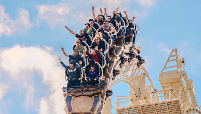 Riders experiencing a thrilling drop on THE SWARM roller coaster at Thorpe Park Resort, Surrey, UK.
