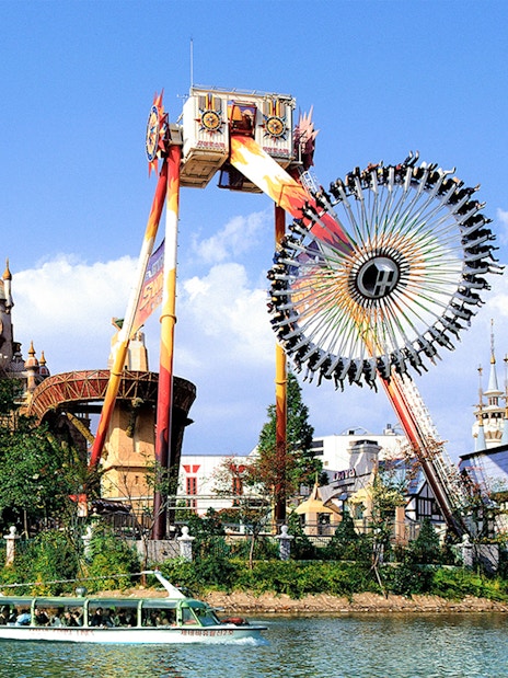 Lotte World amusement park ride with castle backdrop and boat on lake.