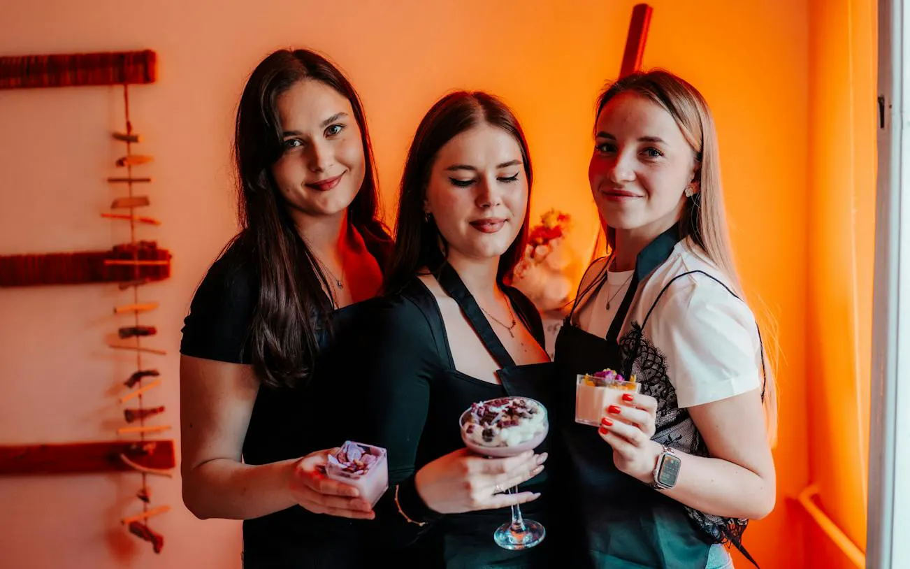 Participants at Krakow candle-making workshop holding scented candles.