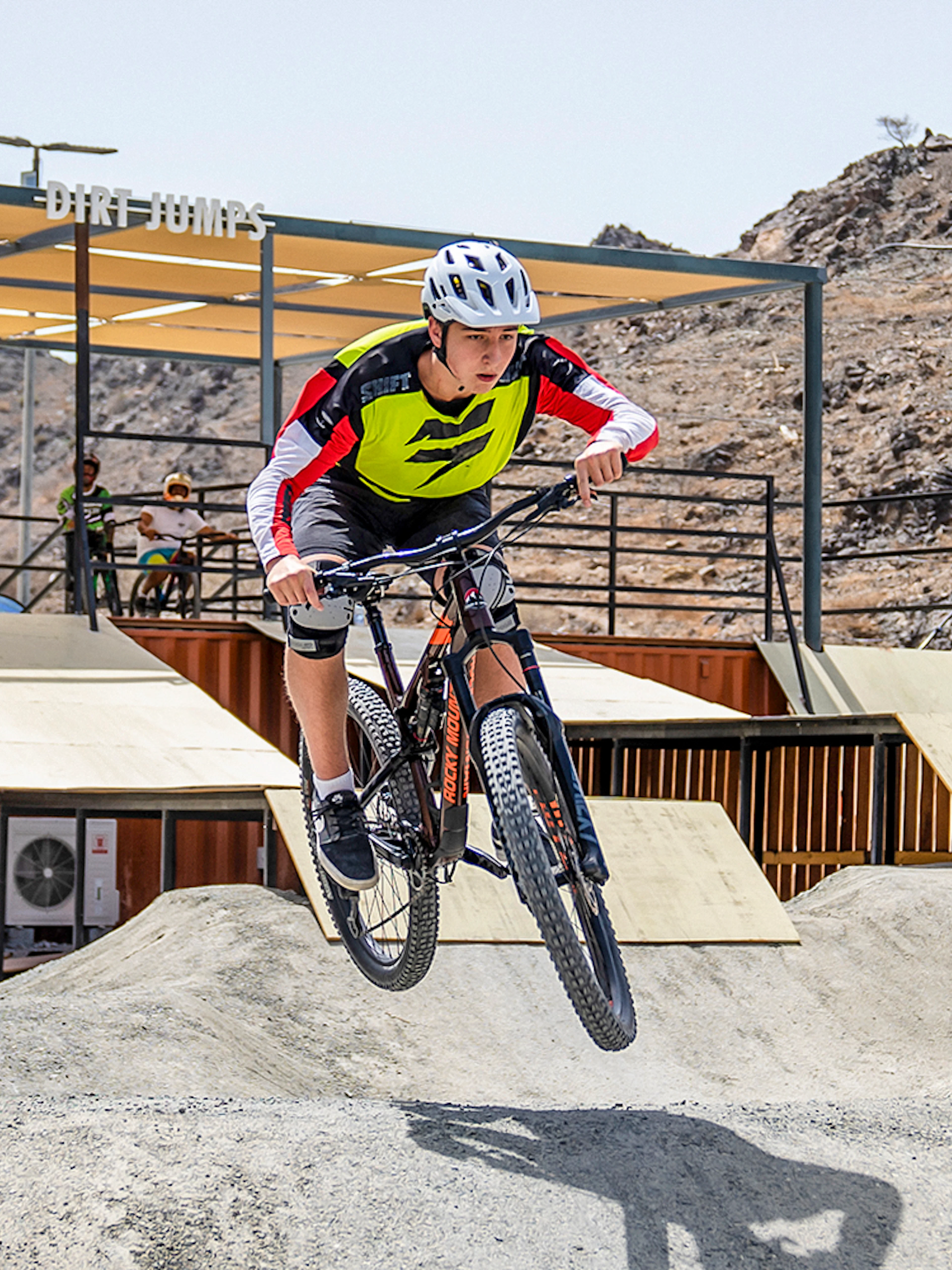 Cyclist jumping on dirt track at Fujairah Adventure Park.