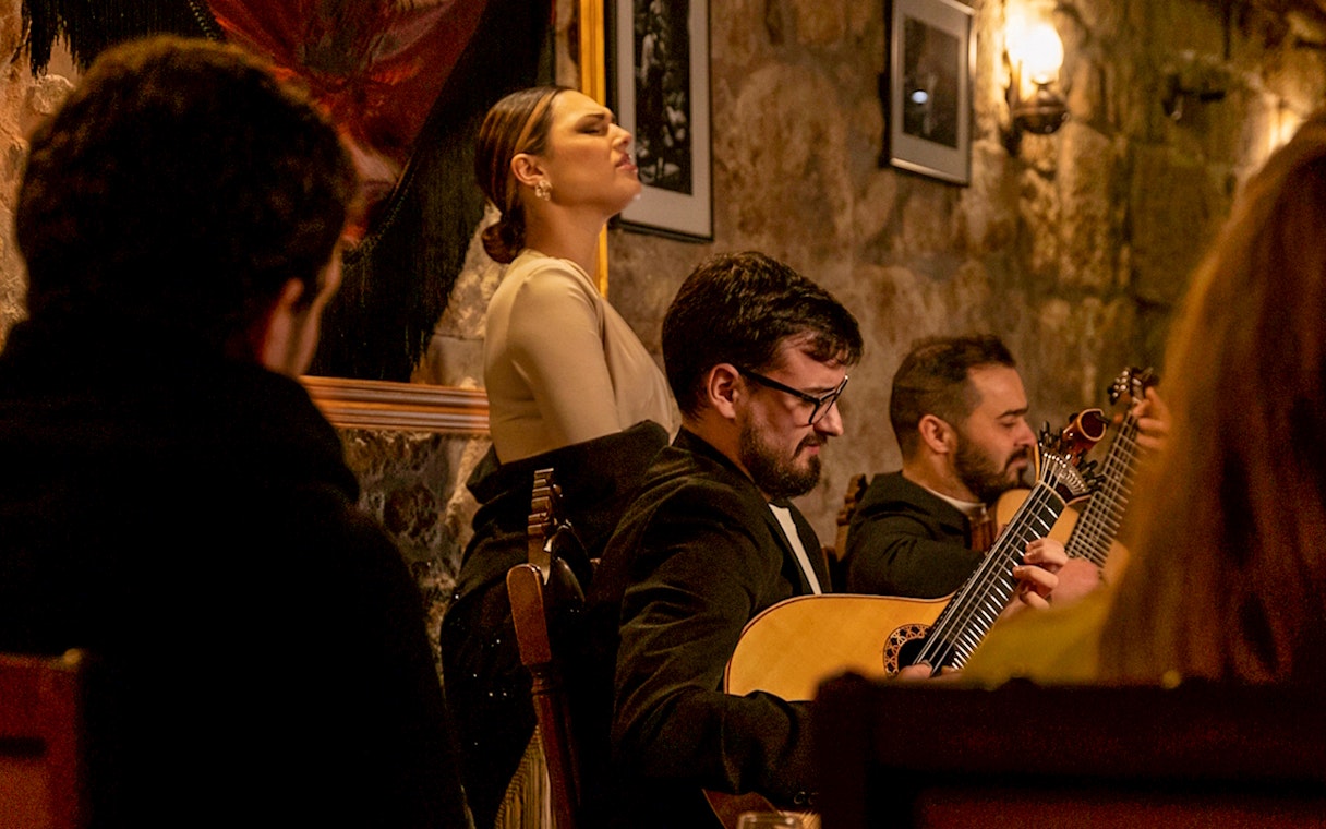Musicians performing at Fado Maior during an intimate Fado show.