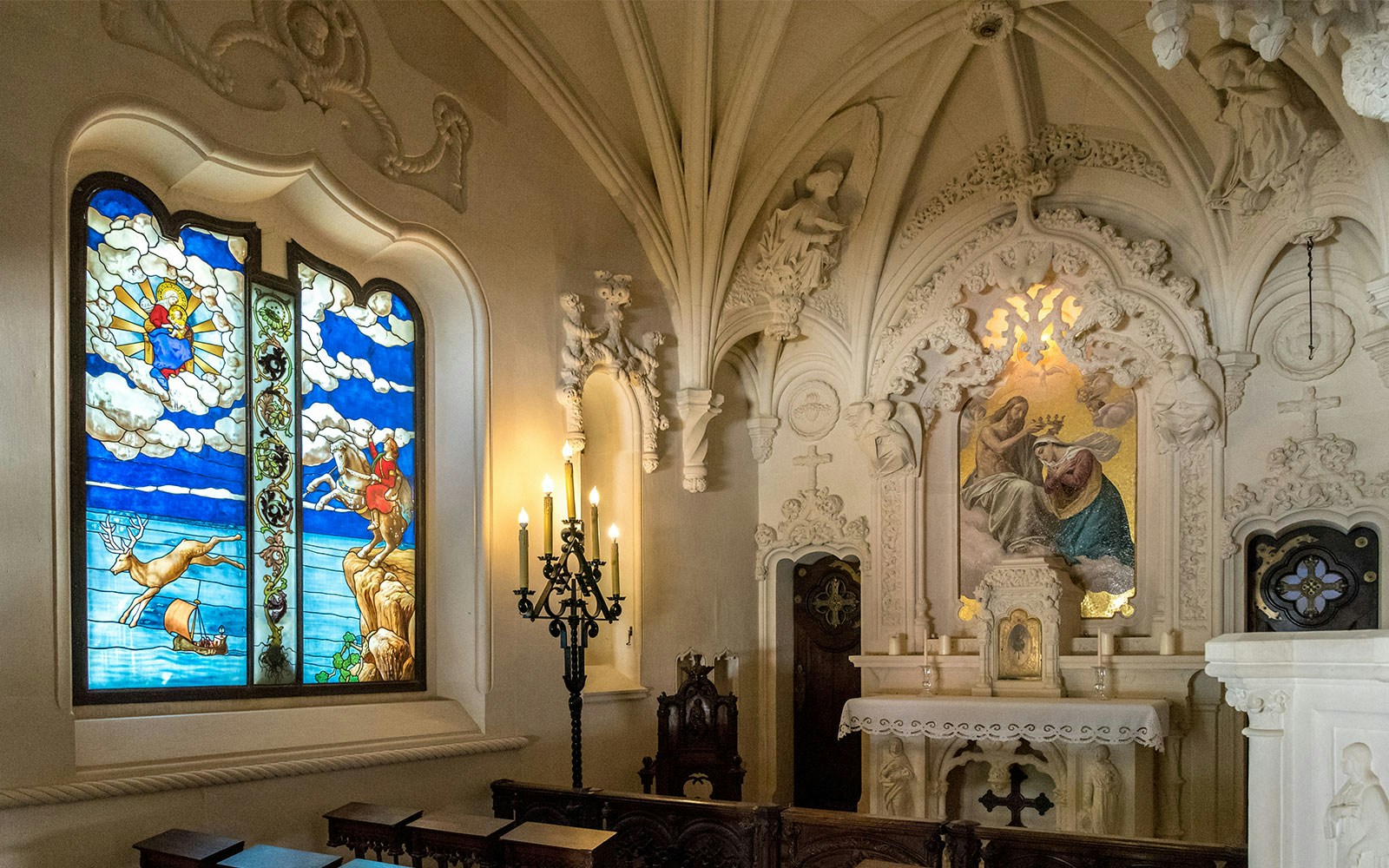 Quinta da Regaleira Chapel interior with ornate altar and intricate stone carvings, Sintra, Portugal.