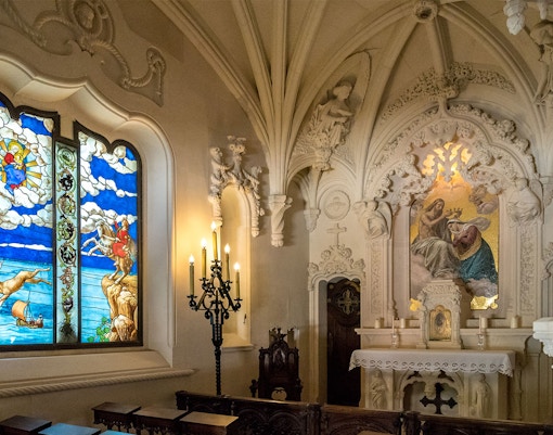 Quinta da Regaleira Chapel interior with ornate altar and intricate stone carvings, Sintra, Portugal.