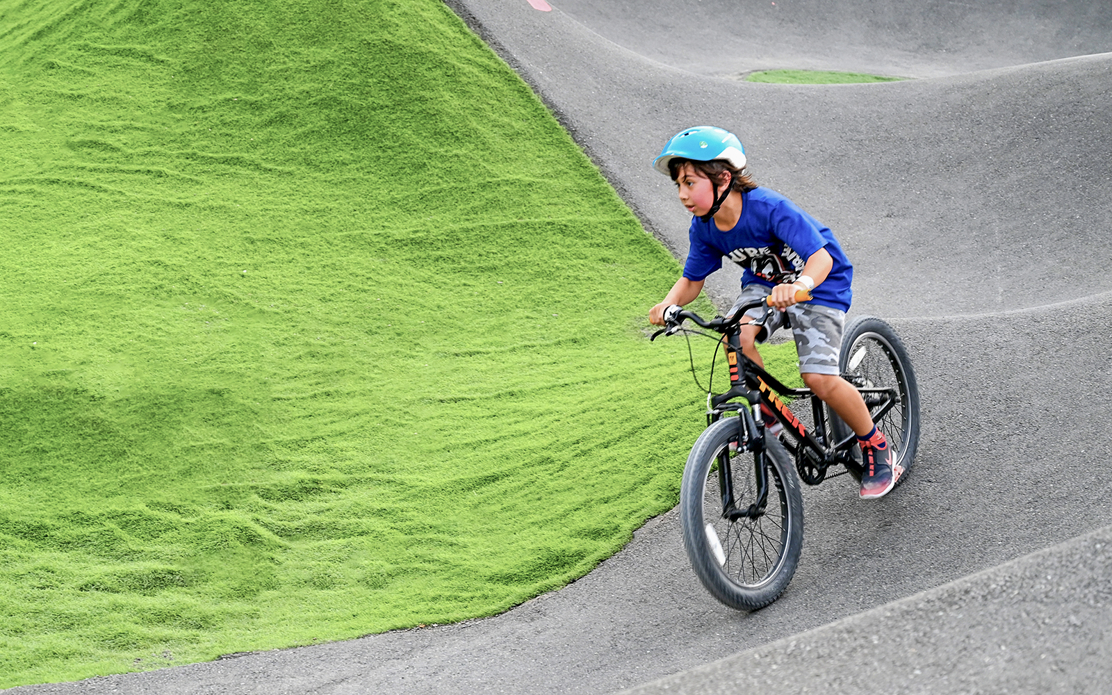 Child biking on pump track at Fujairah Adventure Park.