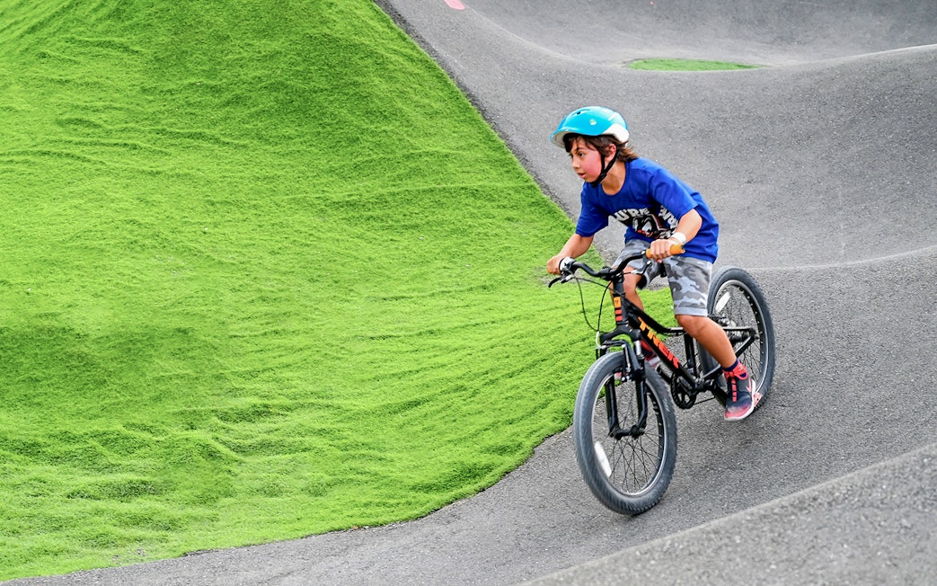 Child biking on pump track at Fujairah Adventure Park.