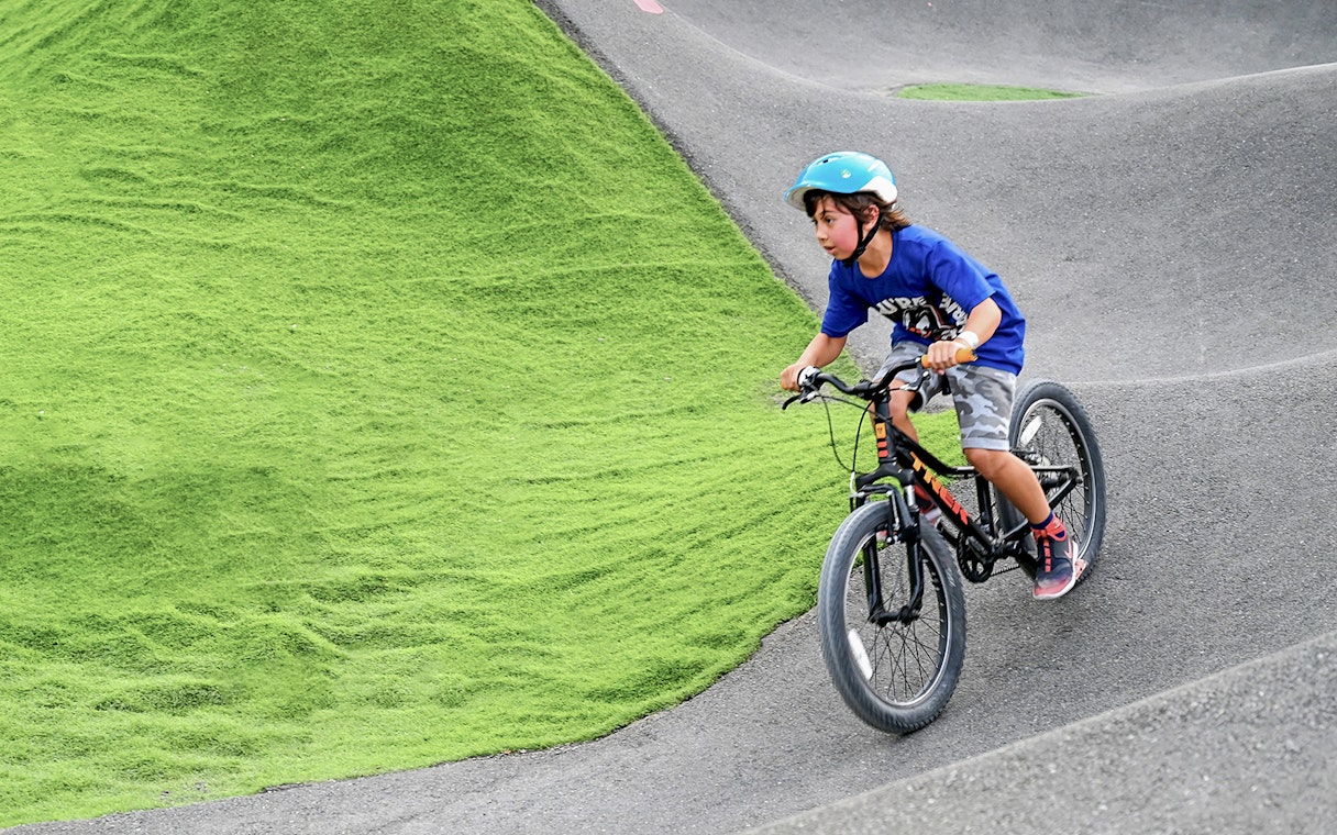 Child biking on pump track at Fujairah Adventure Park.