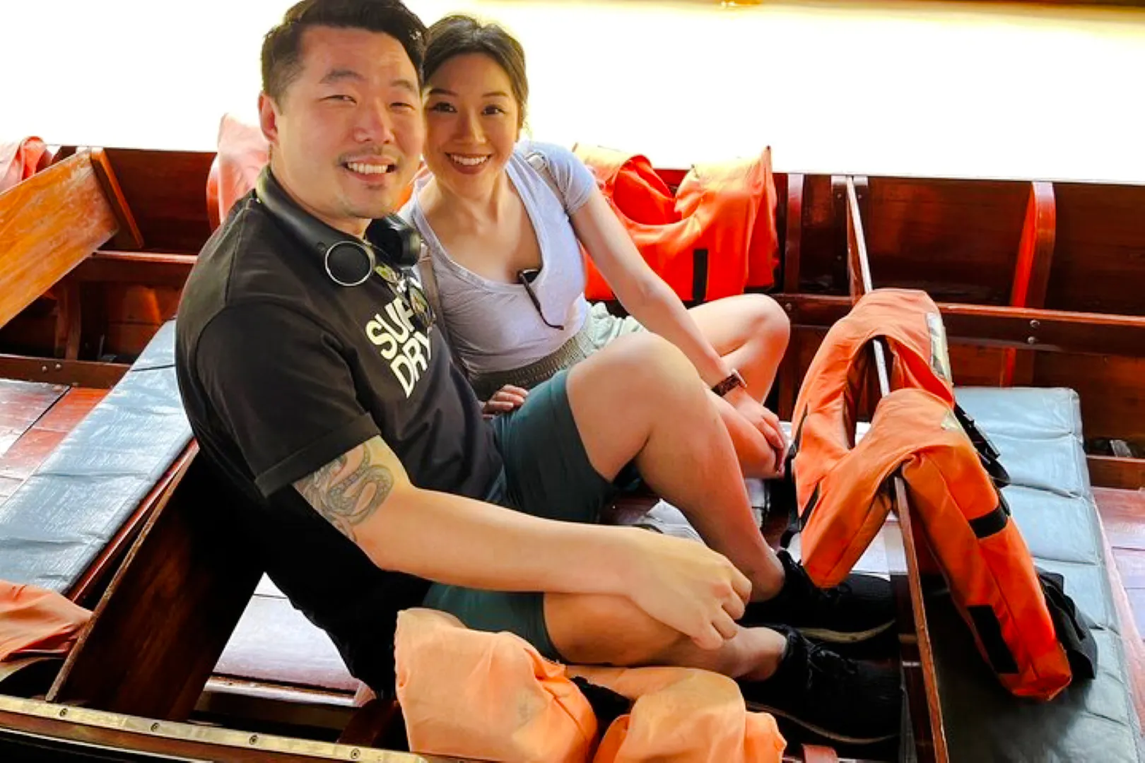 Couple sitting in a boat with life jackets during Floating Market tour from Laem Chabang, Pattaya.