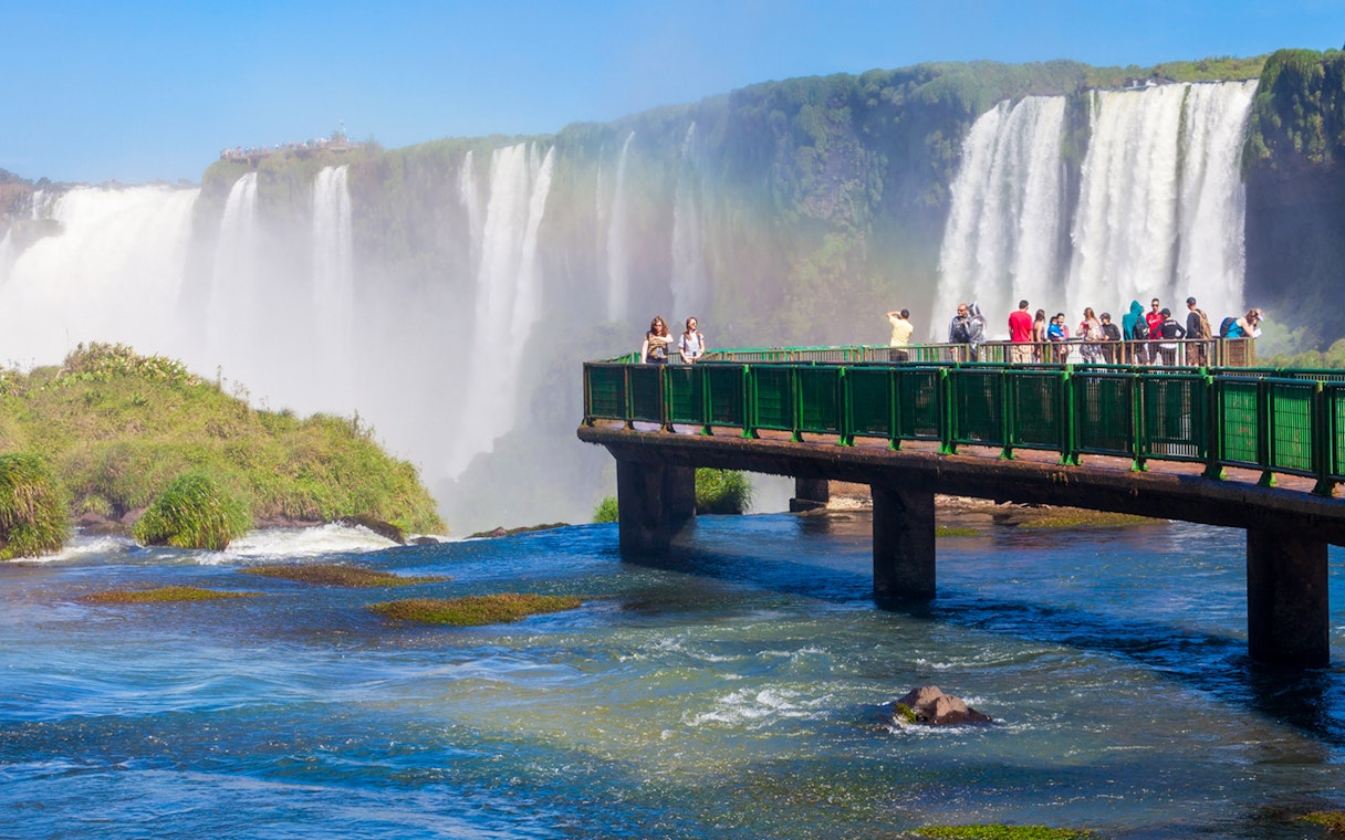 Visitors on a walkway overlooking Iguazu Falls, Argentina.