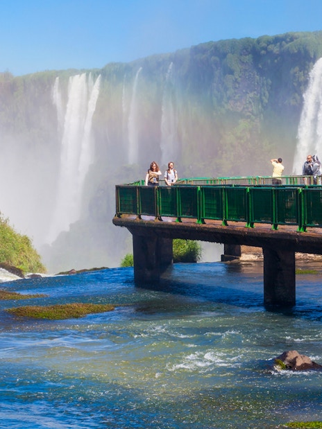Visitors on a walkway overlooking Iguazu Falls, Argentina.