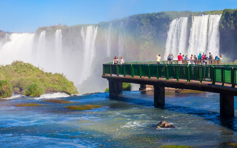 Visitors on a walkway overlooking Iguazu Falls, Argentina.