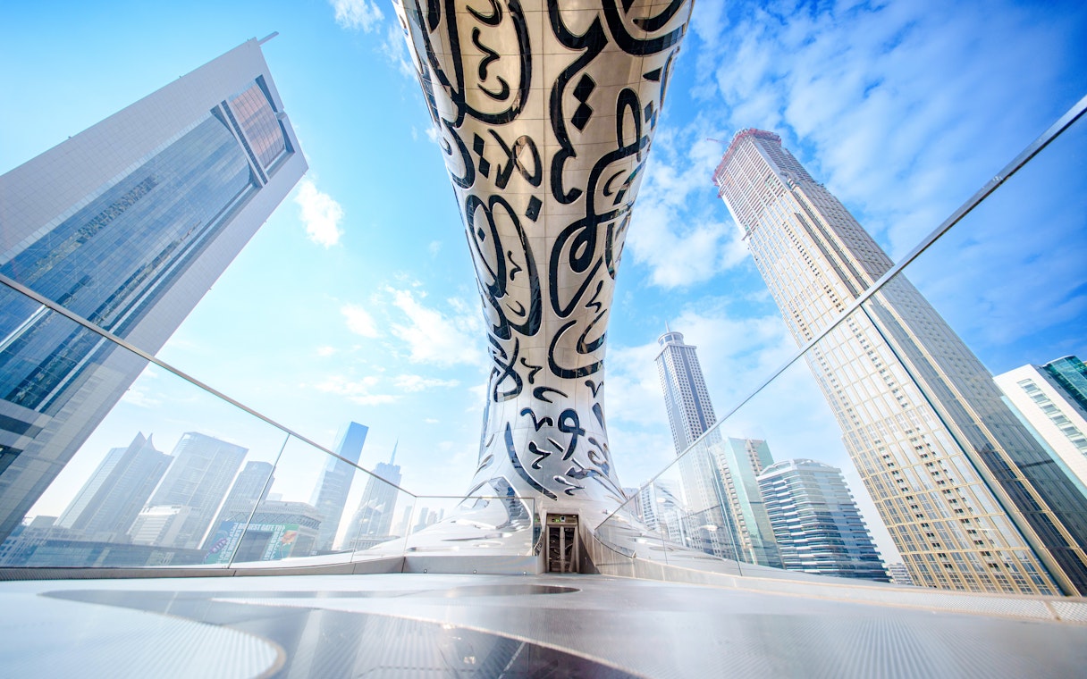 Futuristic architecture of the Museum of the Future in Dubai with surrounding skyscrapers.
