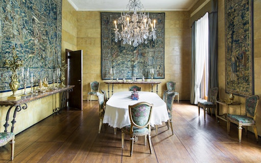 Dining room with ornate tapestries and chandelier at Villa Necchi Campiglio, Milan.