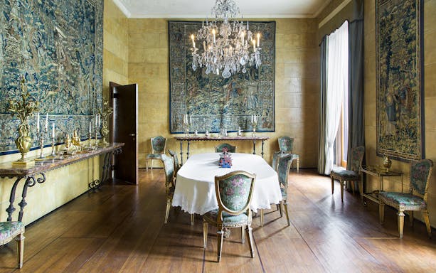 Dining room with ornate tapestries and chandelier at Villa Necchi Campiglio, Milan.