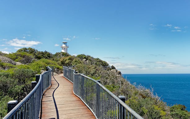 Coastal path leading to a lighthouse near Wineglass Bay, Tasmania.