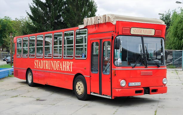 Red tour bus for Saxon Switzerland and Pillnitz Castle guided tour.