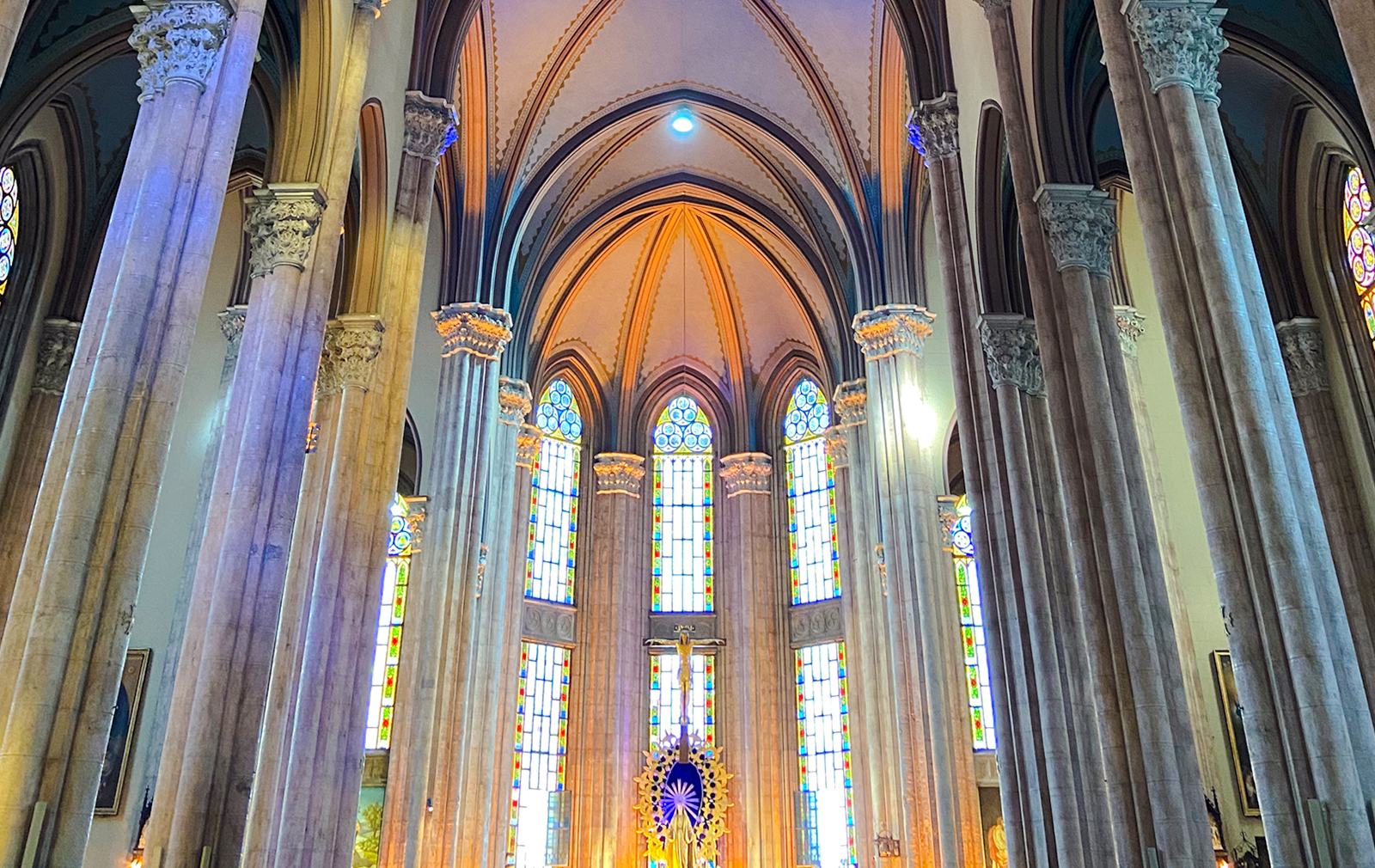 Interior view of The Church of St. Anthony of Padua in Istanbul with stained glass windows and arches.