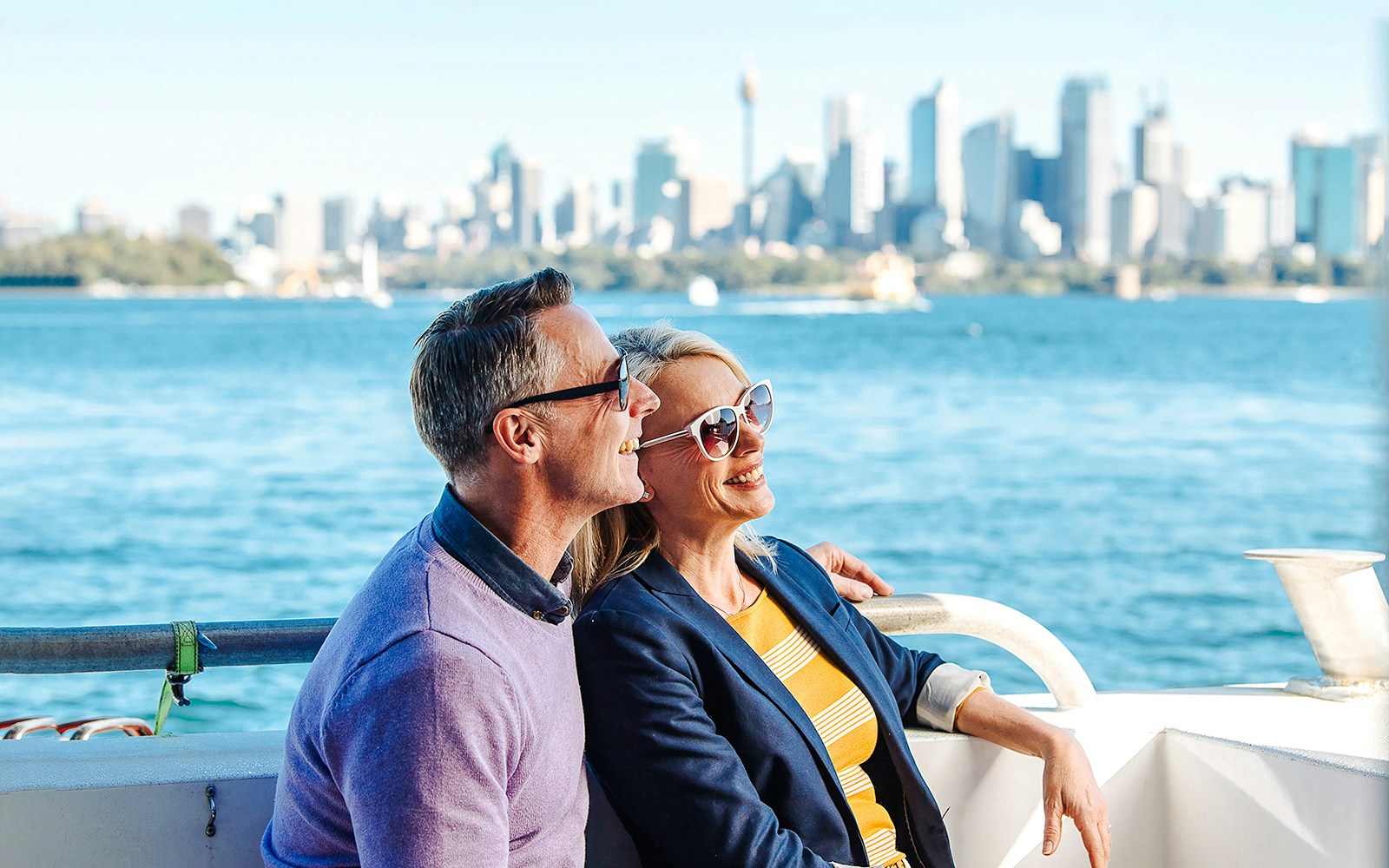 Couple on a boat watching whales in Sydney Harbour, Australia.